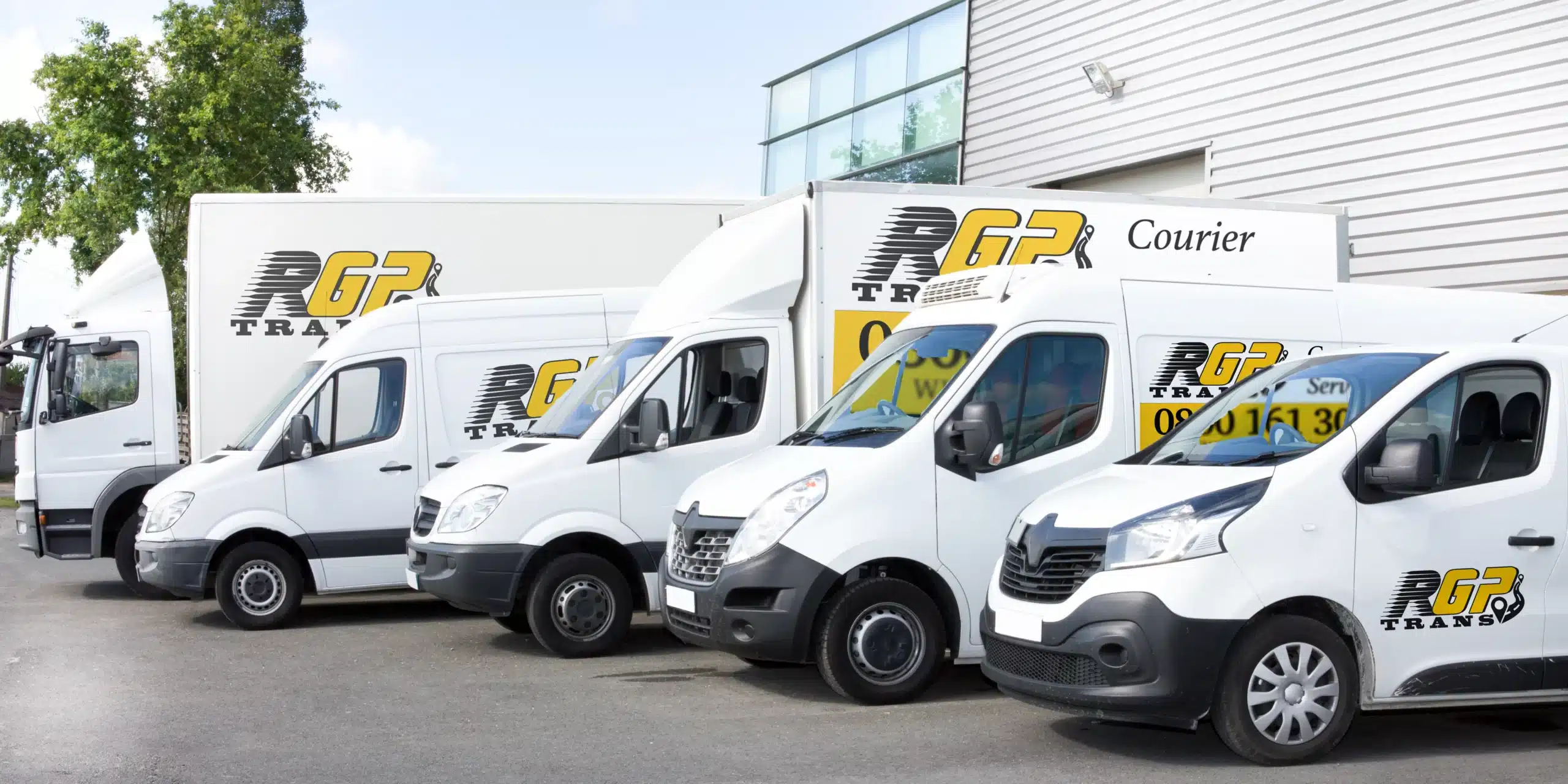 fleet of vans parked outside a warehouse